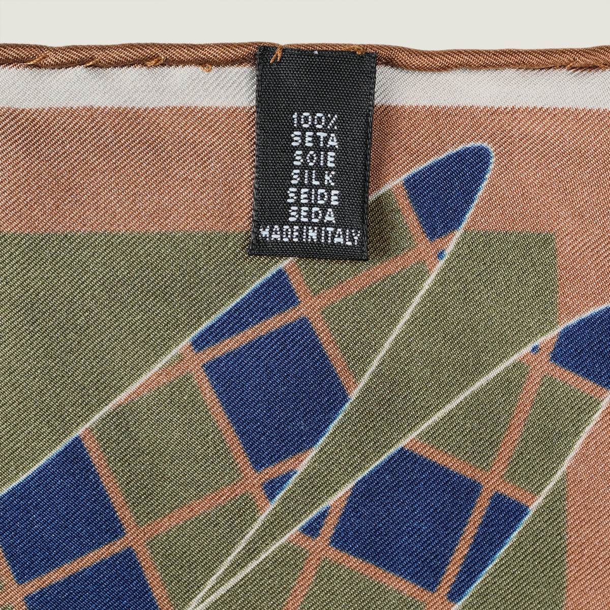 The Graft silk carré, reverse side — woven label: 100% silk, made in Italy