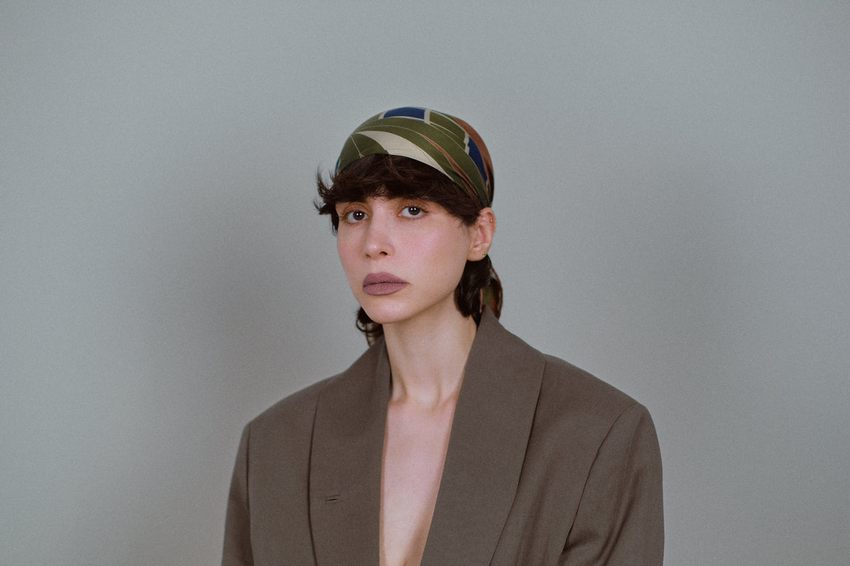 The Graft silk carré folded into a headband, seen from the front