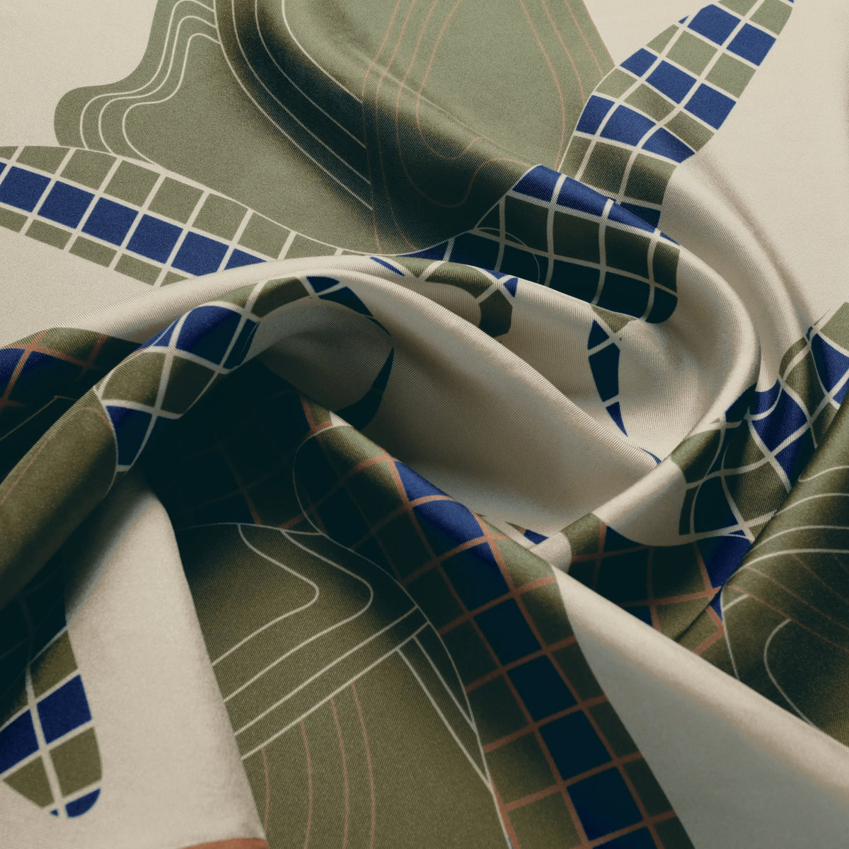 The Quatrefoil silk carré, draped — the sheen of the silk twill