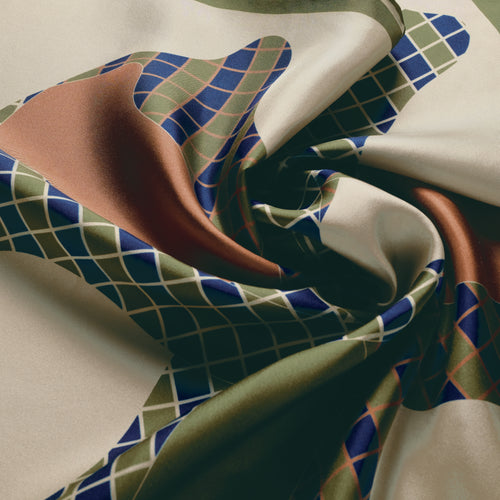 The Crossing silk carré, draped — the sheen of the silk twill