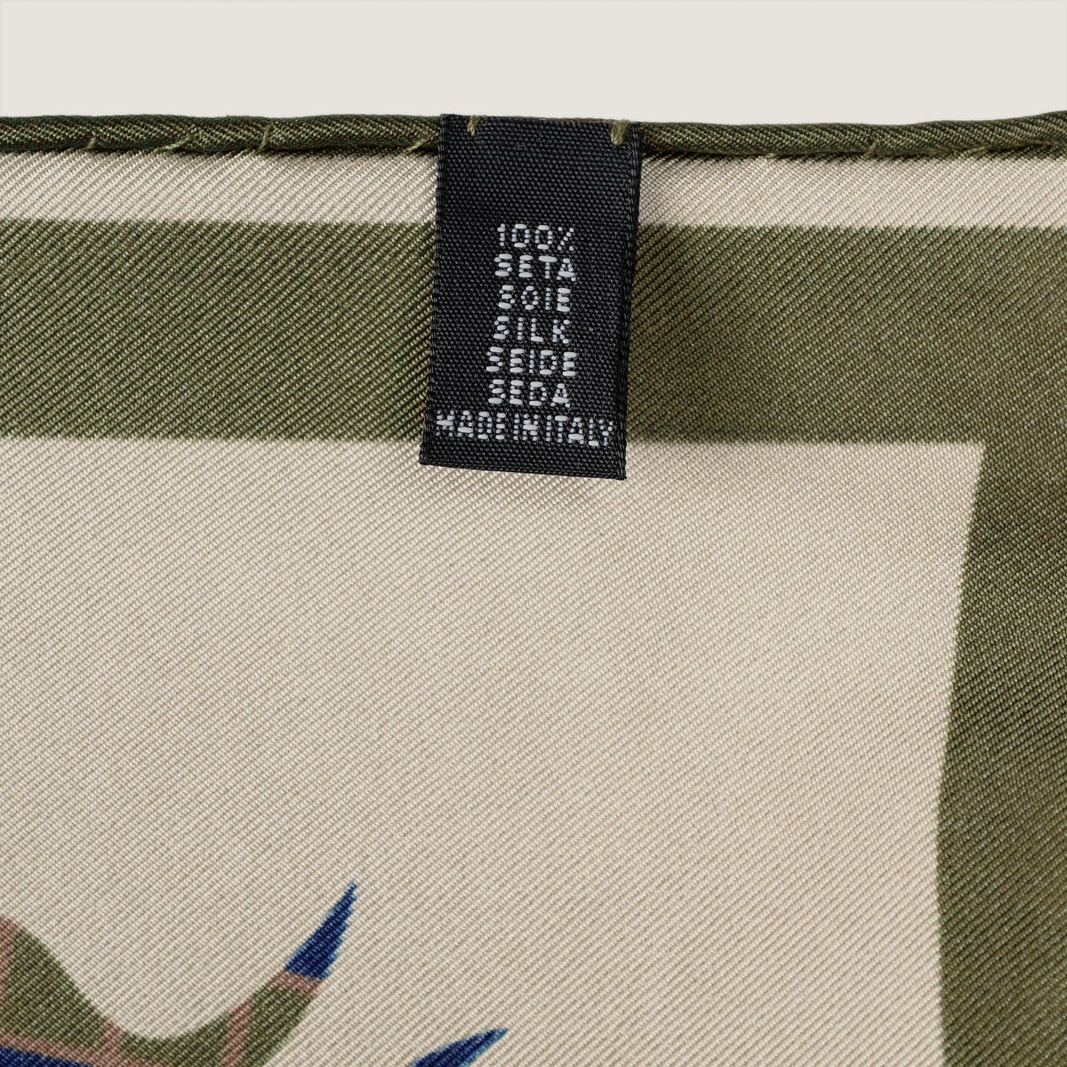 The Crossing silk carré, reverse side — woven label: 100% silk, made in Italy
