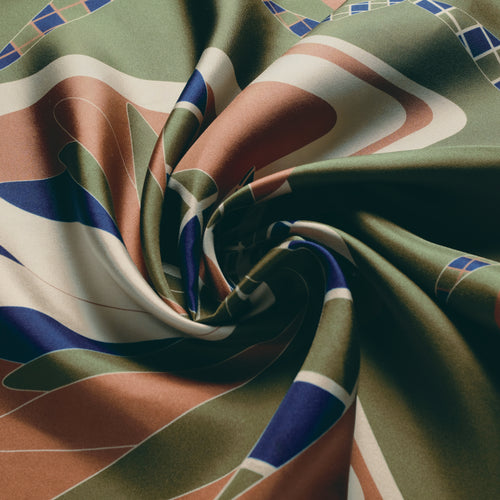 The Graft silk carré, draped — the sheen of the silk twill