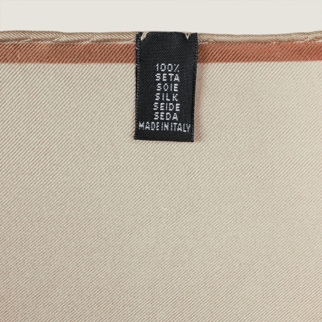 The Quatrefoil silk carré, reverse side — woven label: 100% silk, made in Italy
